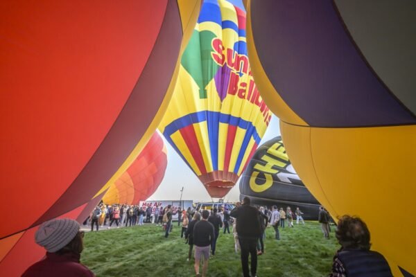 A "magical" fleet of hot air balloons flies at an international festival amid warm temperatures