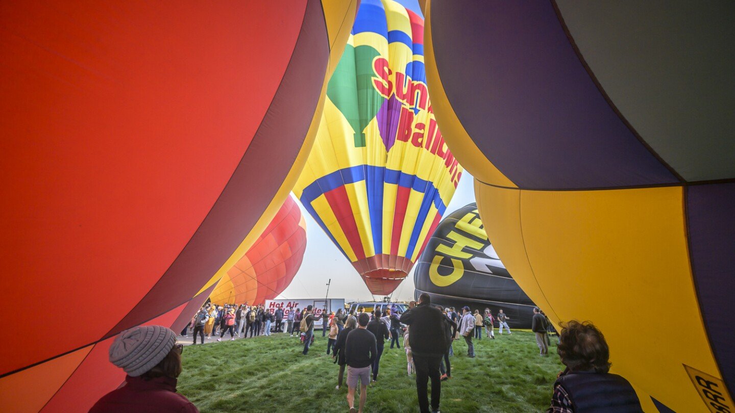 A "magical" fleet of hot air balloons flies at an international festival amid warm temperatures