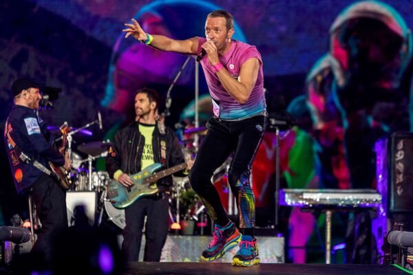 Coldplay's Chris Martin falls through a trapdoor onto the stage during a concert